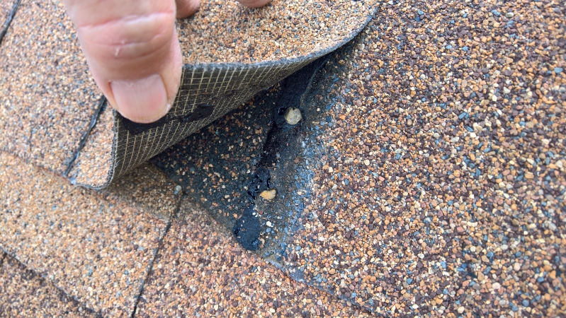 RSN ridge shingle nails-both over driven and placed incorrectly into factory sealant